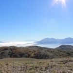 Panorama mozzafiato delle montagne abruzzesi, con vette innevate e cielo blu.